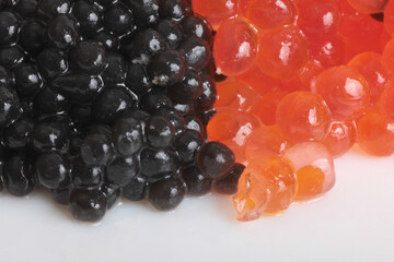 Red caviar lies on bread. Isolated object on a white background
