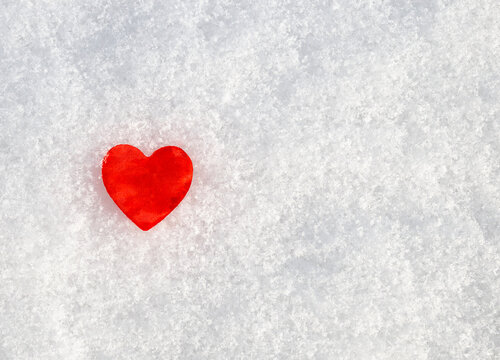 concept Valentines Day: red heart in the snow