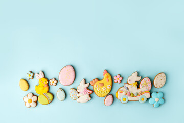 Set of Colorful easter cookies on blue background, assortment sweet gifts, seasonal springtime holiday greeting card, creative idea for decor, event menu, funny food, copy space, flyer, invitation