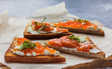 sandwiches of bread red caviar and fish
