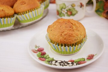 Homemade cupcakes with alamonds and chia seeds on white wooden background coffee cup