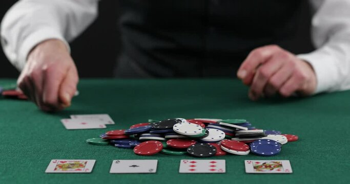 Poker player pulling in a pile of chips, large win, jackpot, successful game. Fortune, luck, gambling . Successful player stacking his chips on the poker 