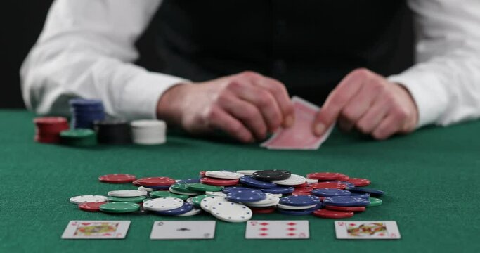 poker player betting all casino chips , poker player looks at the card and bet