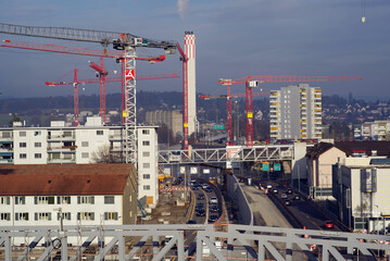 Highway construction site with cranes.