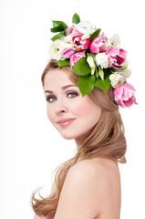 Beauty Spring Girl with Flowers Hair Style. Beautiful Model woman with Blooming flowers on her head. Smile. Spring Flower.Mother's Day. Springtime.