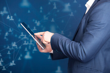 Businessman using tablet, double exposure with network
