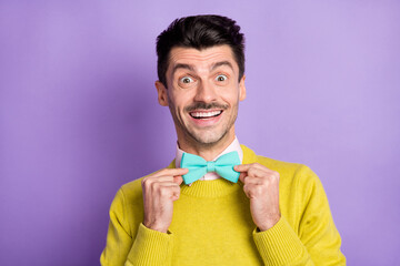 Portrait of brunet optimistic guy touch tie wear yellow sweater isolated on pastel lilac color background