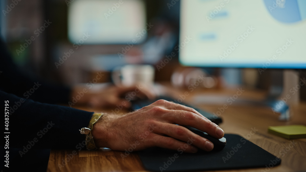 Aufkleber Close Up on Male Hands of a Specialist Working on Desktop Computer in a Busy Creative Office Environment. Manager First Types on a Keyboard and Then Uses the Mouse. He's Wearing a Craft Bracelet.