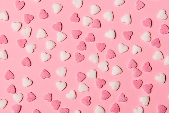 Pink and white hearts on color background