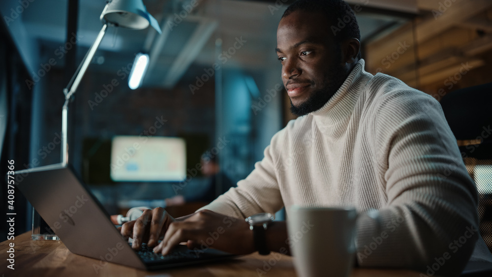 Poster handsome black african american man having an online conversation on a laptop computer in creative o