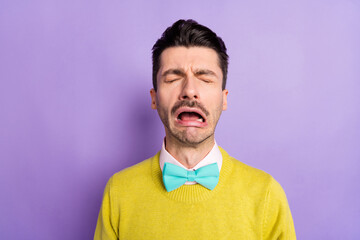 Portrait of brunet crying guy wear yellow sweater isolated on pastel lilac color background