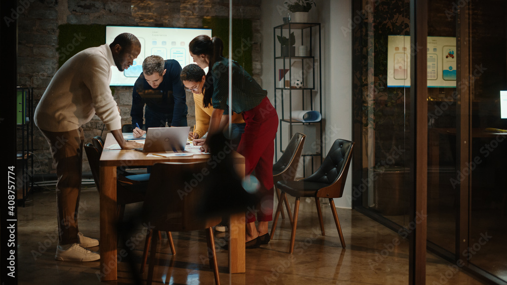 Poster Diverse Multiethnic Team are Having a Conversation in a Meeting Room Behind Glass Walls in a Creative Office. Colleagues Lean On a Conference Table and Discuss Business, App User Interface and Design.