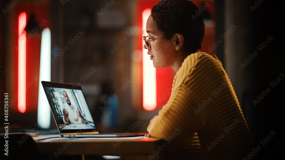 Poster beautiful multiethnic latina project manager is making a video call on laptop computer in creative o