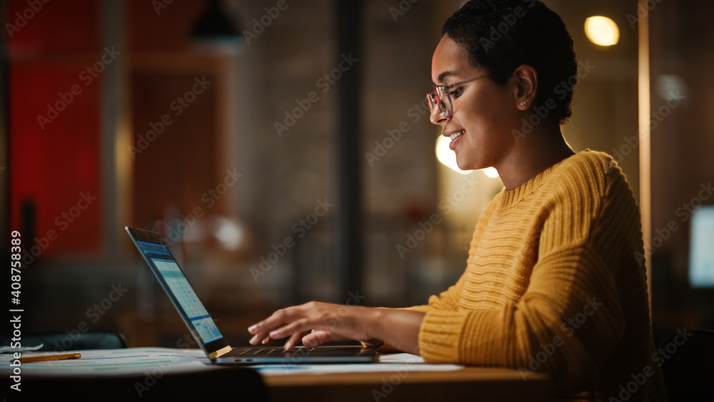 Poster Young Multiethnic Developer Working on a Laptop Computer in Creative Office Environment. Beautiful Diverse Latin Female Project Manager is Developing Data and Scheduling a Project.