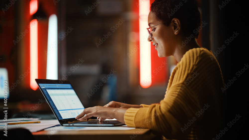 Poster Young Multiethnic Developer Working on a Laptop Computer in Creative Office Environment. Beautiful Diverse Latin Female Project Manager is Developing Data and Scheduling a Project.