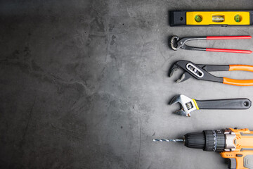 Construction tools on Gray-black cement floor background with copy space.Home Repair concept, Repair maintenance concept, Renovation concept.