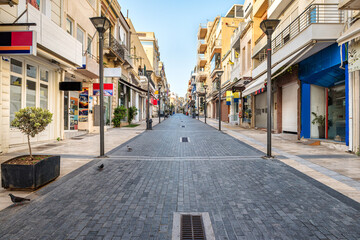 Fototapeta na wymiar One of the main street of the Heraklion center, 25th of August. Empty street, no people. Sunny morning. Selective focus.