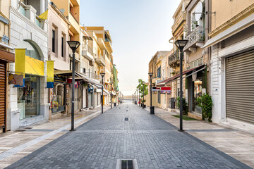 Fototapeta na wymiar One of the main street of the Heraklion center, 25th of August. Empty street, no people. Sunny morning.
