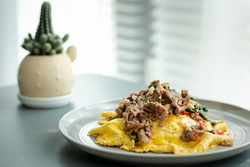 stir fried thai styled basil with beef and omelet topped on rice