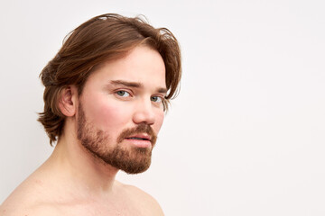 Fototapeta premium sexy shirtless man model with stylish haircut posing at camera isolated on white background, bearded male has natural expression, calm and confident look