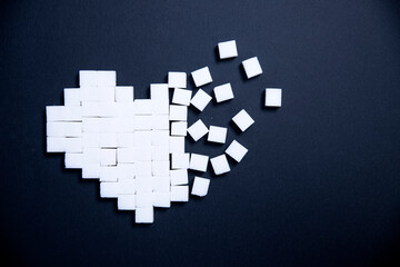  Heart of sugar cubes - unhealthy diet concept.