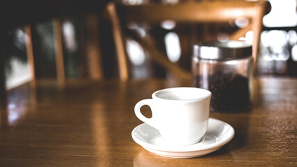 Fototapeta premium Hot coffee americano on the old wooden table.