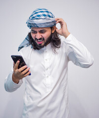Religious man watching social media in the smart phone isolated on a grey background