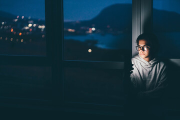 Woman using mobile phone at night.