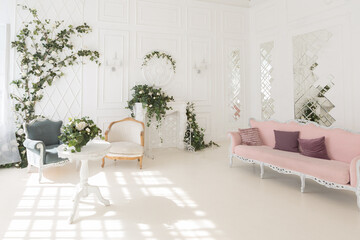 luxury delicate interior of the living room and bedroom in light colors with expensive chic carved furniture in classic style