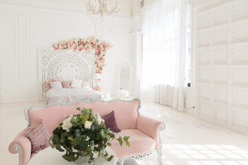 luxury delicate interior of the living room and bedroom in light colors with expensive chic carved furniture in classic style