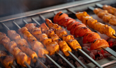 Arabic traditional food Shish taouk and tomato on the grill.