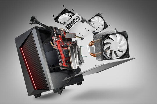 exploded view of a modern computer. hardware components mainboard cpu processor graphic card RAM cables and cooling fan flying out of black red PC case gray abstract technology concept background