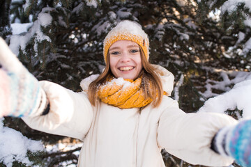 Portrait of a happy smiling girl on a snowy winter day