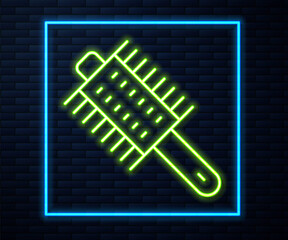 Glowing neon line Hairbrush icon isolated on brick wall background. Comb hair sign. Barber symbol. Vector.