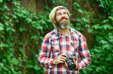 photo shooting outdoor. brutal man traveler with retro camera. photography in modern life. travel tips. professional photographer use vintage camera. bearded man hipster take photo. idyllic vacation