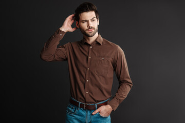 Thinking handsome unshaven guy posing and looking aside