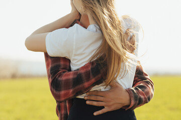 Cropped shot of young couple embracing together at the nature. Happiness concept.