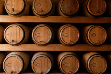 Wooden wine barrels placed on wooden shelves