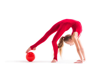 gymnast girl in a red jumpsuit does an exercise with ball on white background, isolate.