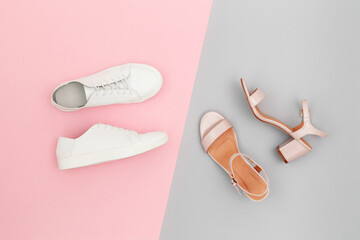 White sneakers and pink heeled sandals on grey and pink paper background. Stylish spring or summer woman's shoes in pastel colors. Trendy beauty female fashion background. Flat lay, top view. - obrazy, fototapety, plakaty