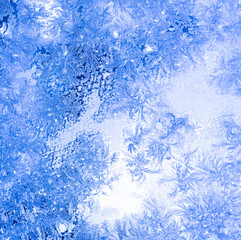 Fototapeta na wymiar blue texture of frost ice surface with frozen design tracery ,cold cryslallized surface background ,winter glass side close up , abstract macro wallpaper