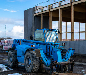 Fototapeta premium Vendée, France; January 24, 2021: a blue telescopic cart on the construction site of the future sports hall of the Saint Gilles Croix de Vie high school.