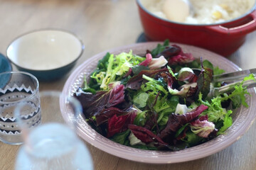 Rustic bowl with lettuce and cabbage salad. Selective focus.