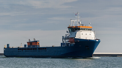 Naklejka premium MERCHANT VESSEL - A ship with a load is traveling on a waterway