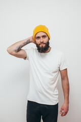 Young bearded hipster guy wearing white blank t-shirt. Mock-up for print. T-shirt template.