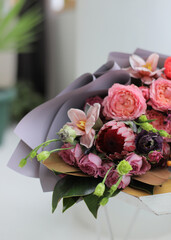 Beautiful flowers in living room interior. Bouquet of colorful fresh flowers on wood table. Home decor. Spring or holiday concept, March 8, International Womens Day, birthday.