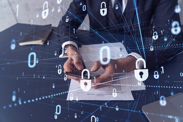 A businessman in formal wear reading the contract to prevent probability of risks in cyber security and checking details in the phone. Padlock Hologram icons over the working desk.