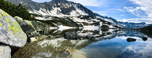 Stunning view of the Tatra mountains reflecting in the water of Morskie Oko lake, Poland © John Nzoka/Wirestock