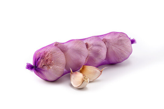 Mesh bag of garlic cloves isolated on white background
