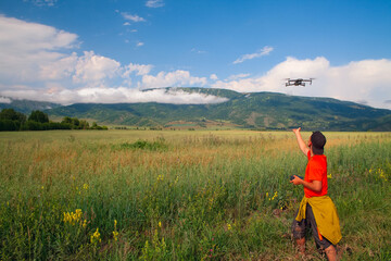Fototapeta na wymiar A man launches a quadcopter into the sky.
